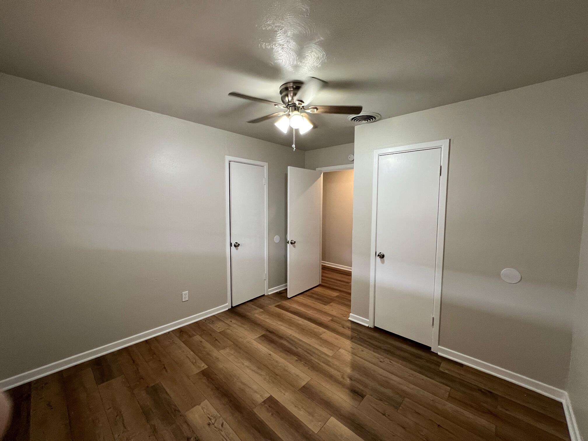 4403 31st Street, Unit A Lubbock, TX 79410 - Photo 6 of 11 an empty room with closet and a ceiling fan