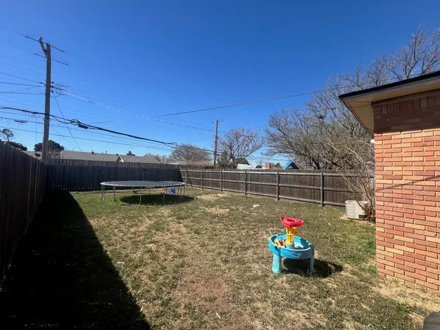 a backyard of a house with a table and chairs