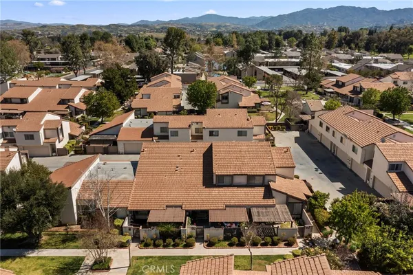 a view of a house with backyard and sitting area