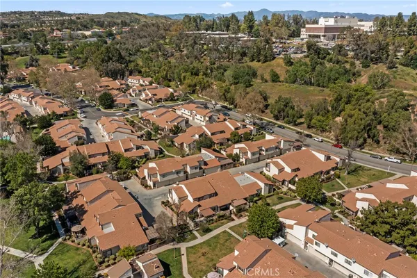 an aerial view of a house with a yard and outdoor seating