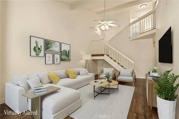 an empty room with wooden floor and staircase