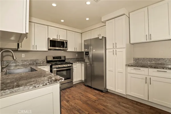 a kitchen with stainless steel appliances a stove sink and refrigerator