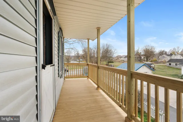 a view of a balcony with wooden floor