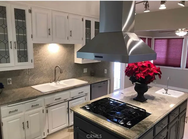a kitchen with stainless steel appliances granite countertop a sink stove and cabinets