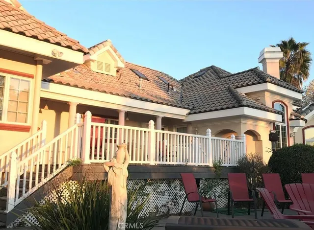 a view of a house with a wooden fence