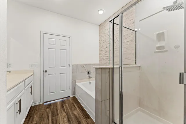 a bathroom with a tub and shower