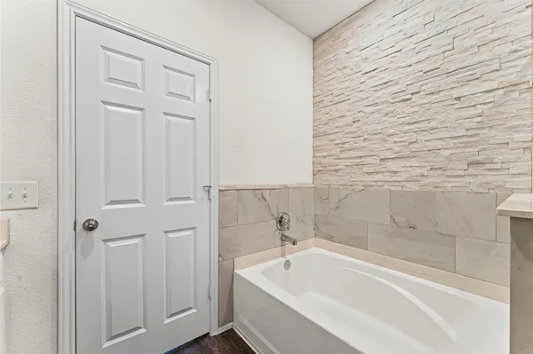 a bathroom with a sink and a mirror with bathtub