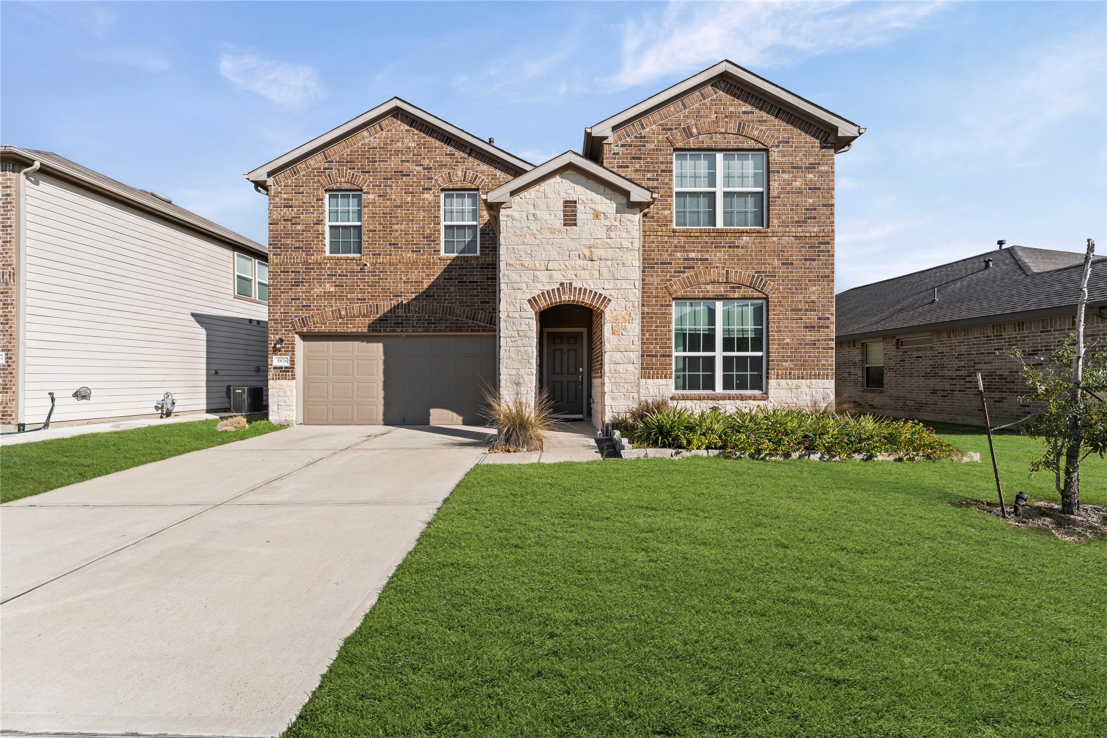 5826 Savanna Pasture Road Katy, TX 77493 - Photo 2 of 45 a front view of a house with a yard and garage