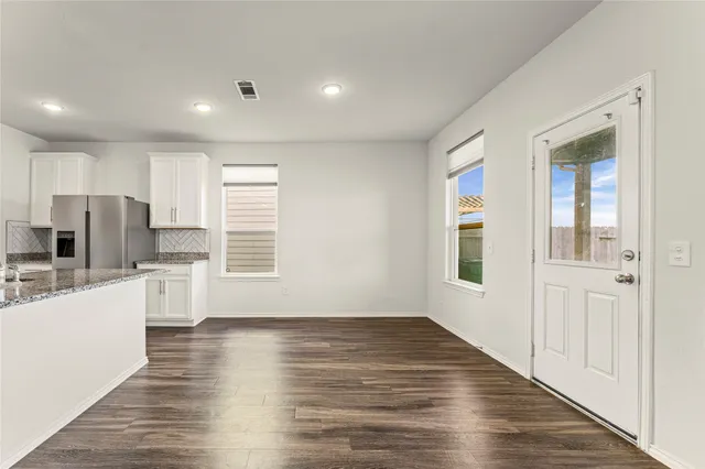 a kitchen with stainless steel appliances granite countertop a sink stove and cabinets