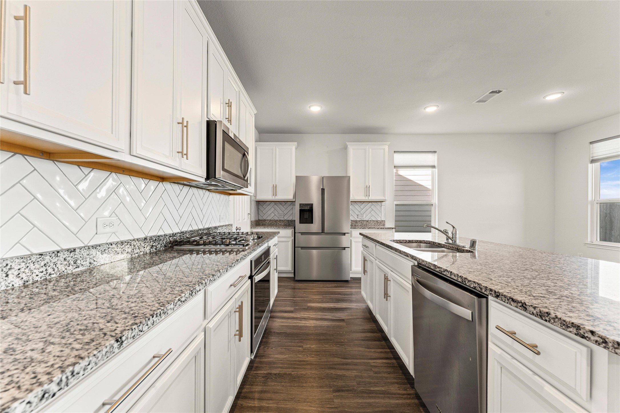 5826 Savanna Pasture Road Katy, TX 77493 - Photo 27 of 45 a large kitchen with stainless steel appliances granite countertop a lot of counter space and a sink