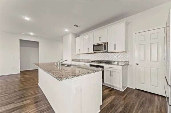 a view of a storage & utility room with wooden floor