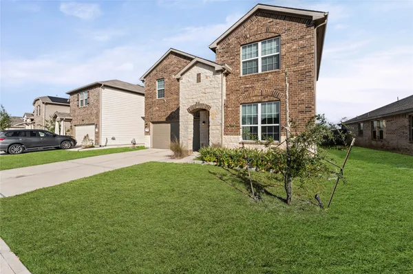 a front view of a house with a yard