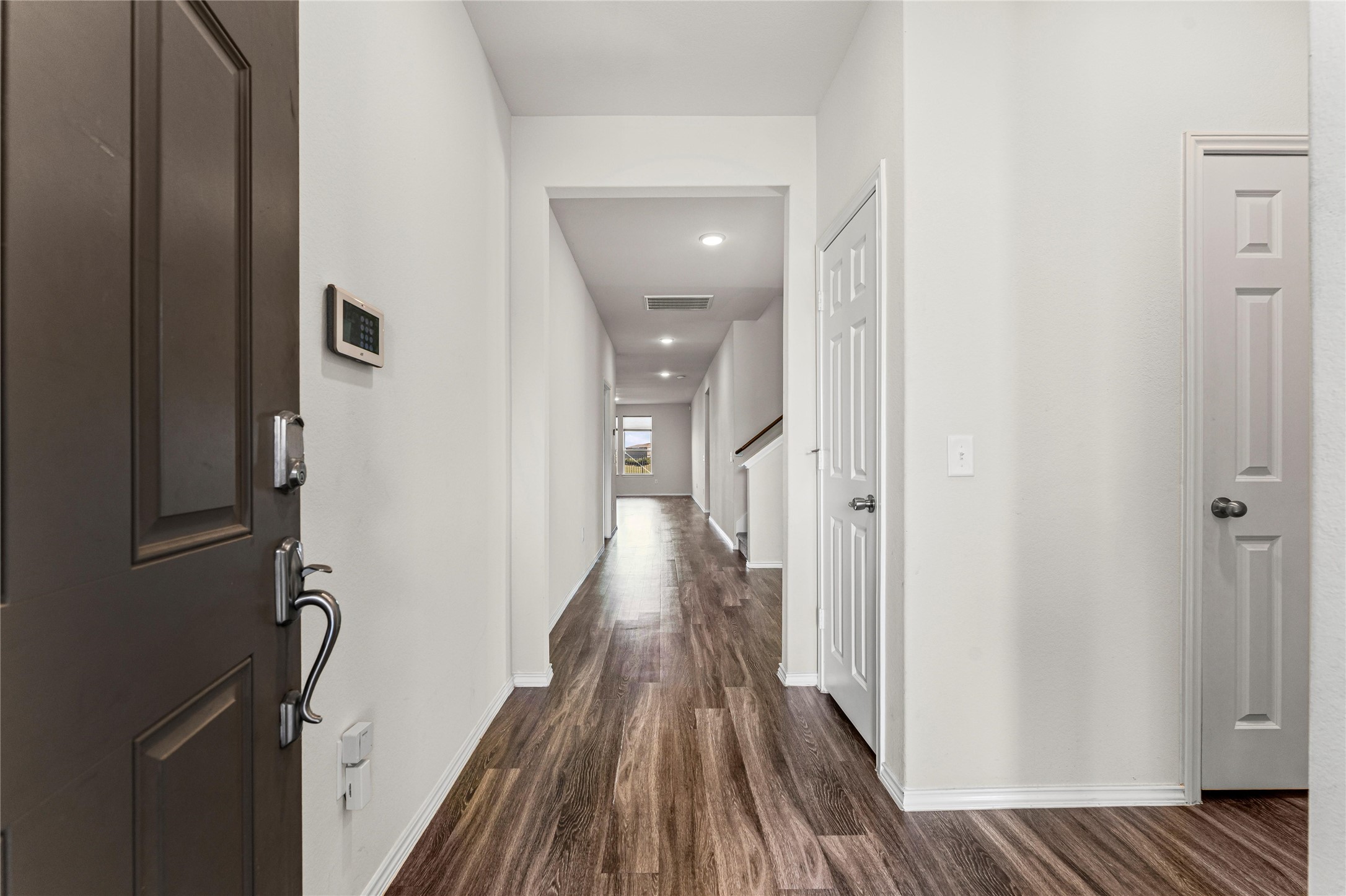 5826 Savanna Pasture Road Katy, TX 77493 - Photo 6 of 45 a view of a hallway with wooden floor and staircase