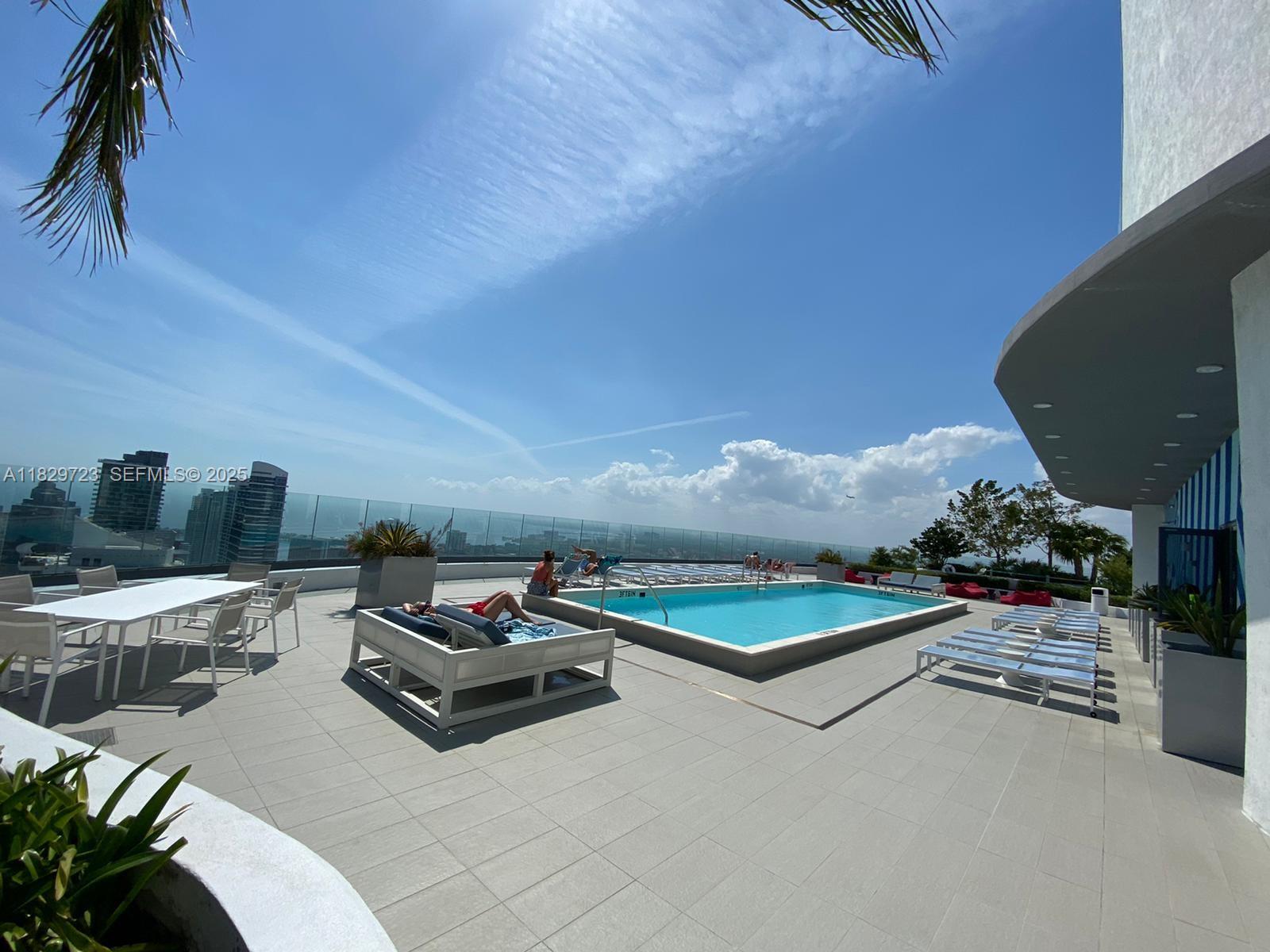 45 Southwest 9th Street, Unit 1706 Miami, FL 33130 - Photo 28 of 29 a living room with furniture and a table