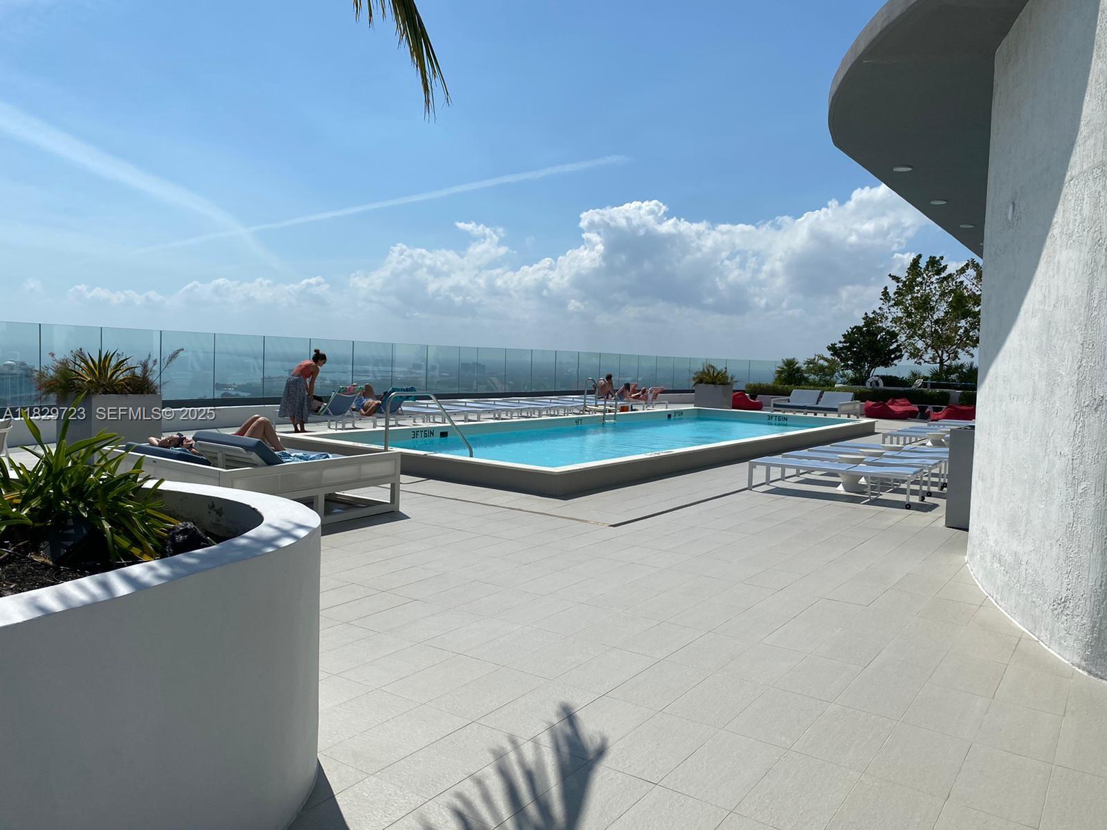 45 Southwest 9th Street, Unit 1706 Miami, FL 33130 - Photo 29 of 29 a view of swimming pool with outdoor seating and plants
