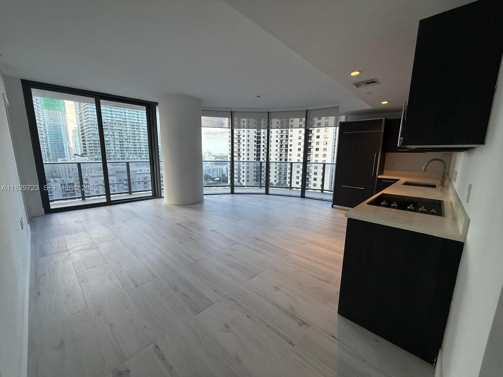 45 Southwest 9th Street, Unit 1706 Miami, FL 33130 - Photo 5 of 29 a view of workspace with furniture and flat screen tv