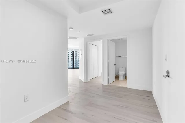 a view of empty room with wooden floor