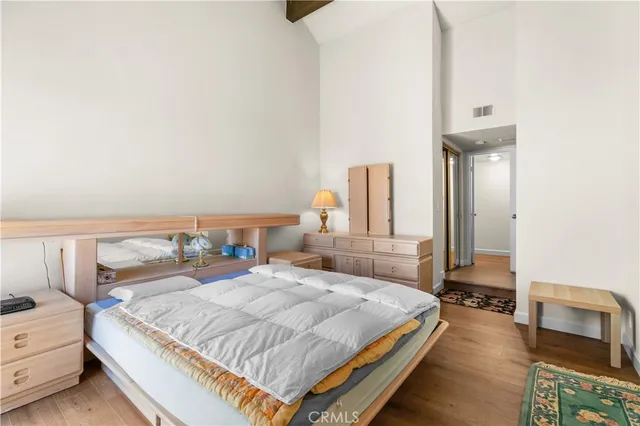 a bedroom with a bed and a night stand