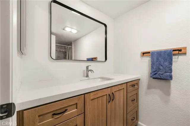a bathroom with a sink a vanity and a mirror