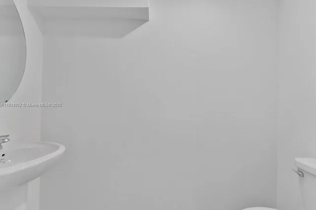 a bathroom with a sink and mirror