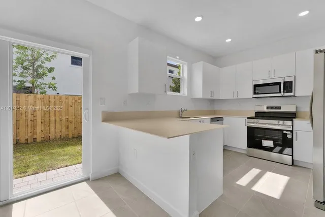 a kitchen with a stove a sink and a microwave