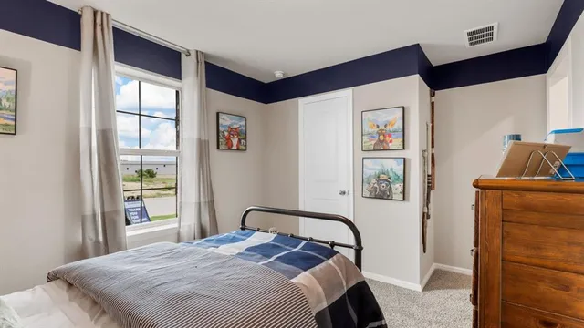 a bedroom with a bed and a dresser