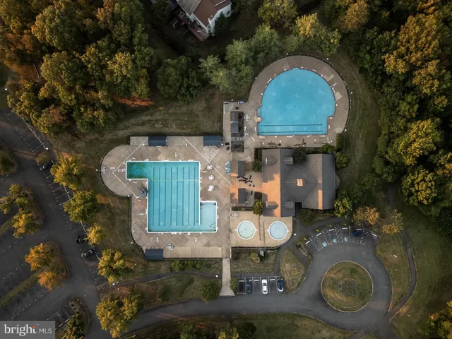 an aerial view of a house with garden space and sitting area