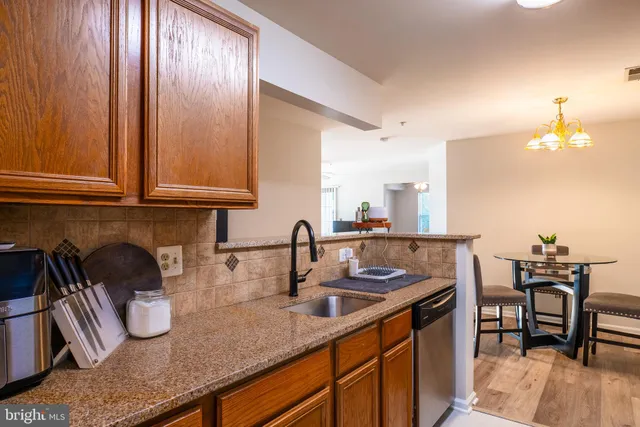 a kitchen with sink and cabinets