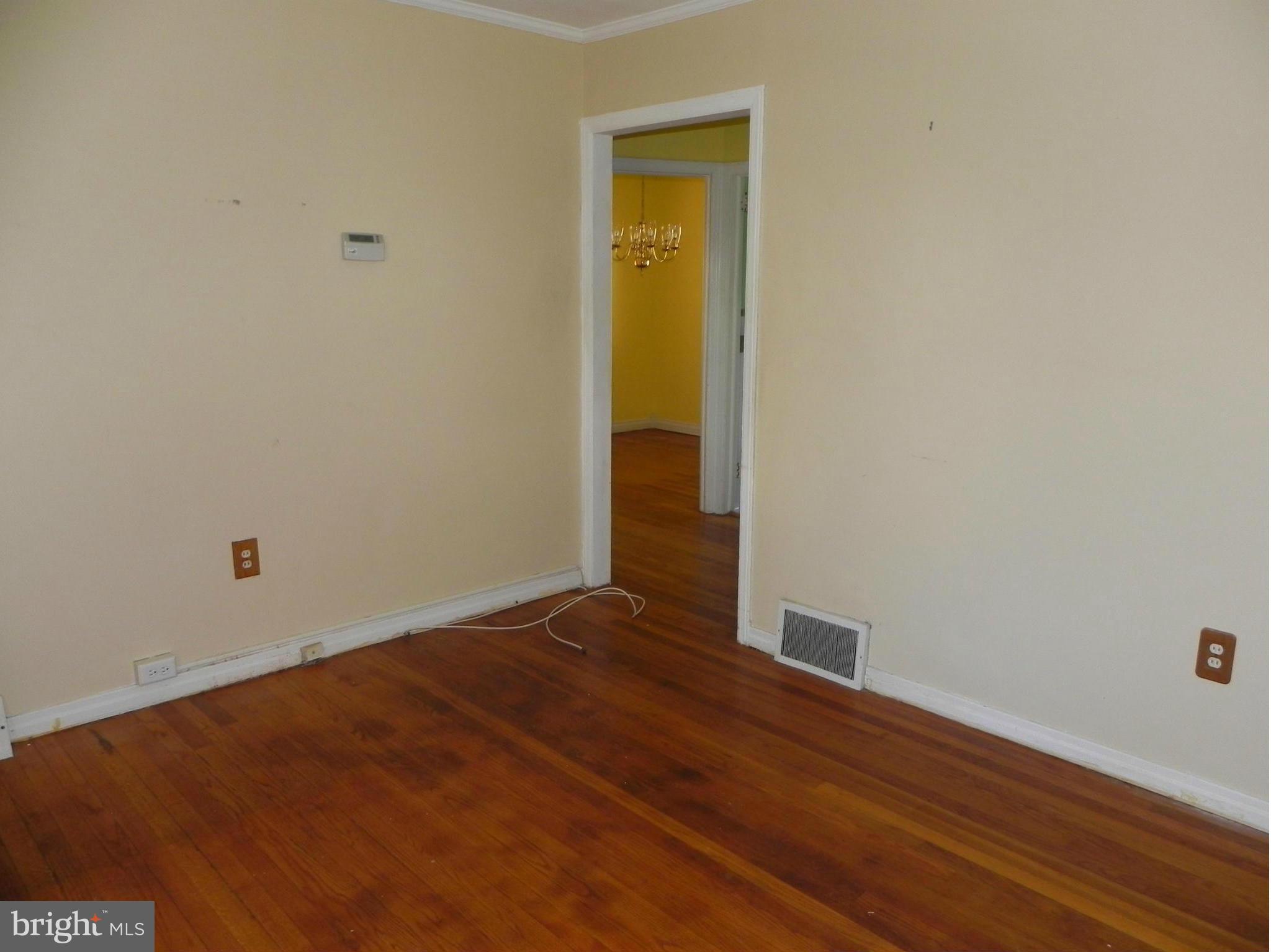 4509 Bennion Road Silver Spring, MD 20906 - Photo 3 of 18 a view of an empty room with wooden floor and closet