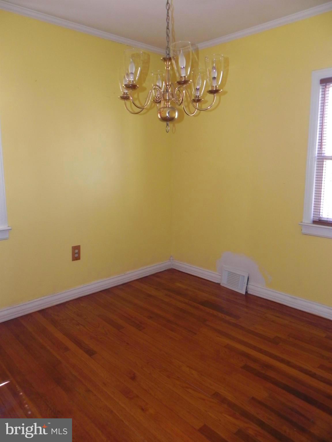 4509 Bennion Road Silver Spring, MD 20906 - Photo 5 of 18 a view of a room with wooden floor and chandelier