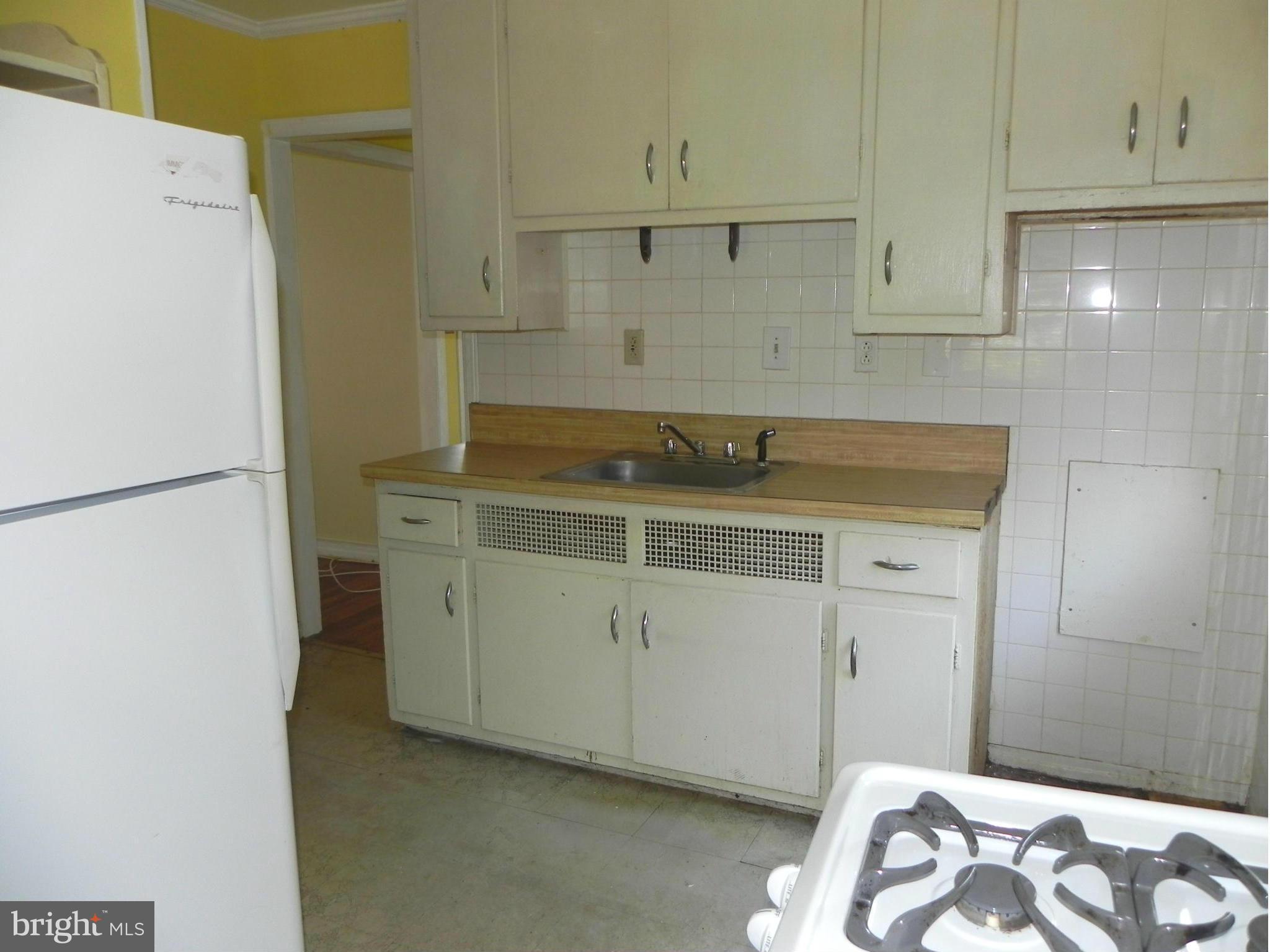 4509 Bennion Road Silver Spring, MD 20906 - Photo 7 of 18 a kitchen with a sink and cabinets