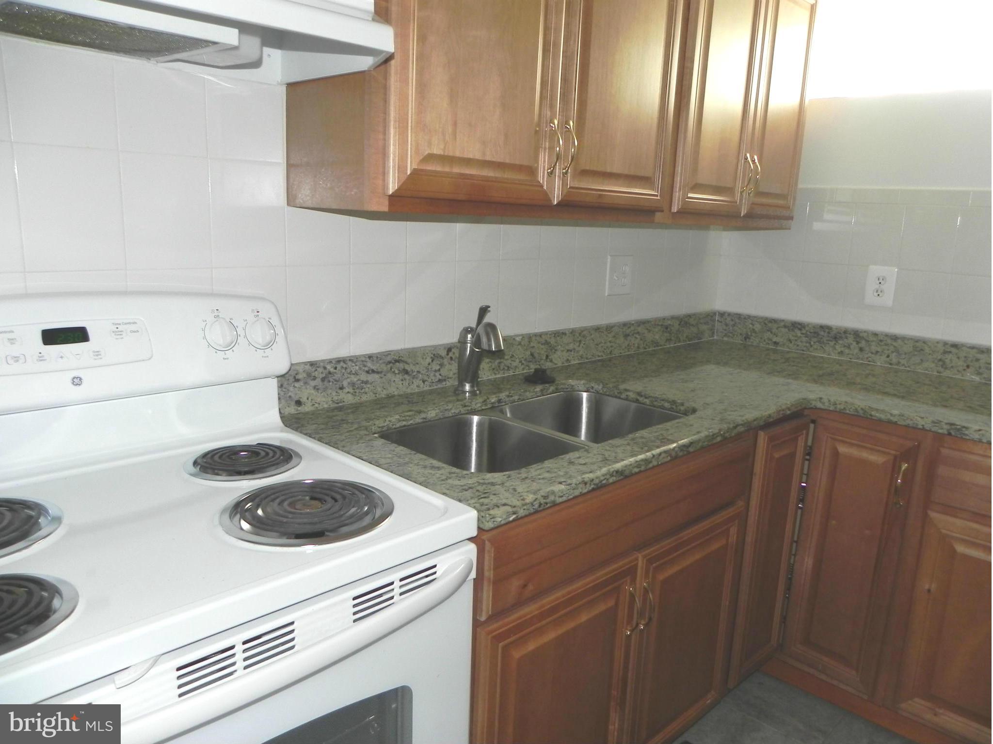 4509 Bennion Road Silver Spring, MD 20906 - Photo 9 of 18 a kitchen with a sink and cabinets