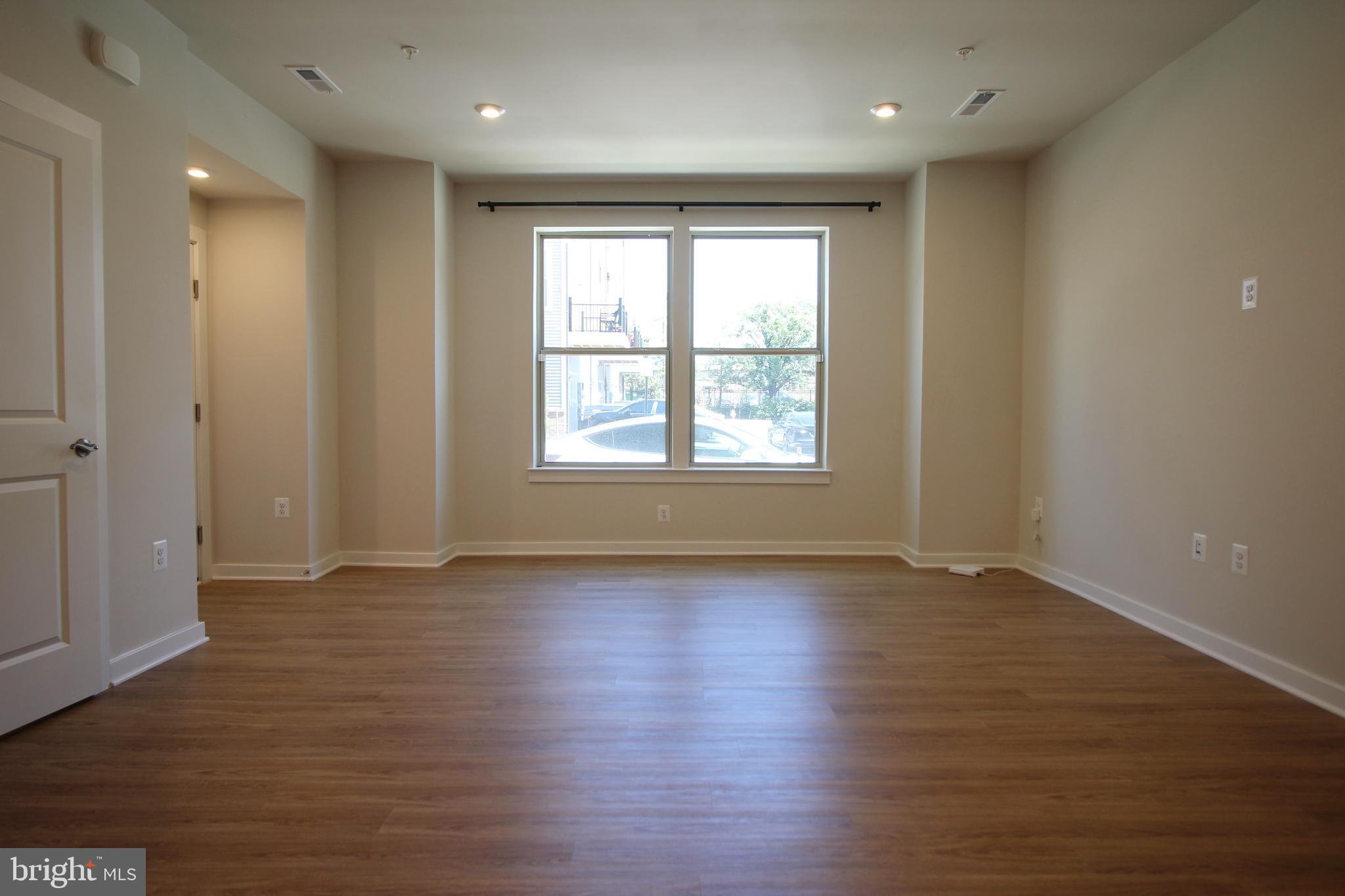 2154 Glacier Road, Unit 67 Herndon, VA 20170 - Photo 4 of 30 an empty room with wooden floor and windows