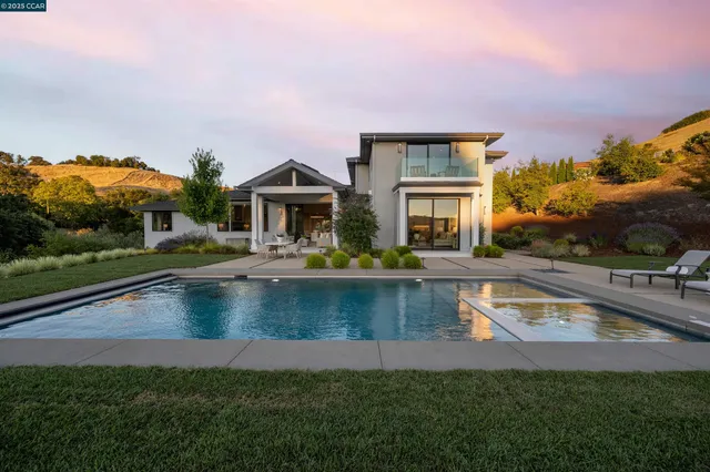 a front view of house with yard outdoor seating and yard in back