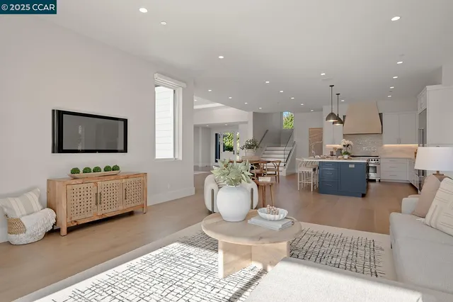 a living room with furniture a window and a potted plant