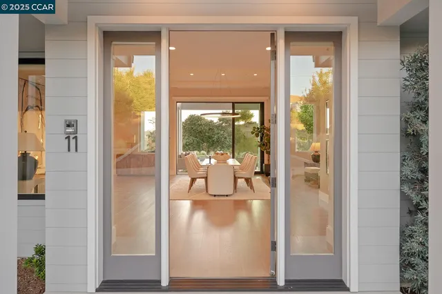 a living room with fireplace furniture and a large window