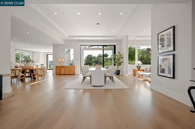 a kitchen with stainless steel appliances granite countertop a sink a stove and a wooden floors