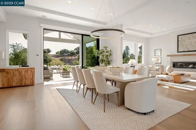 a dining room with furniture and potted plants