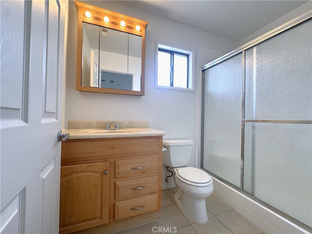44450 Lowtree Avenue Lancaster, CA 93534 - Photo 18 of 24 a bathroom with a toilet a sink and a mirror