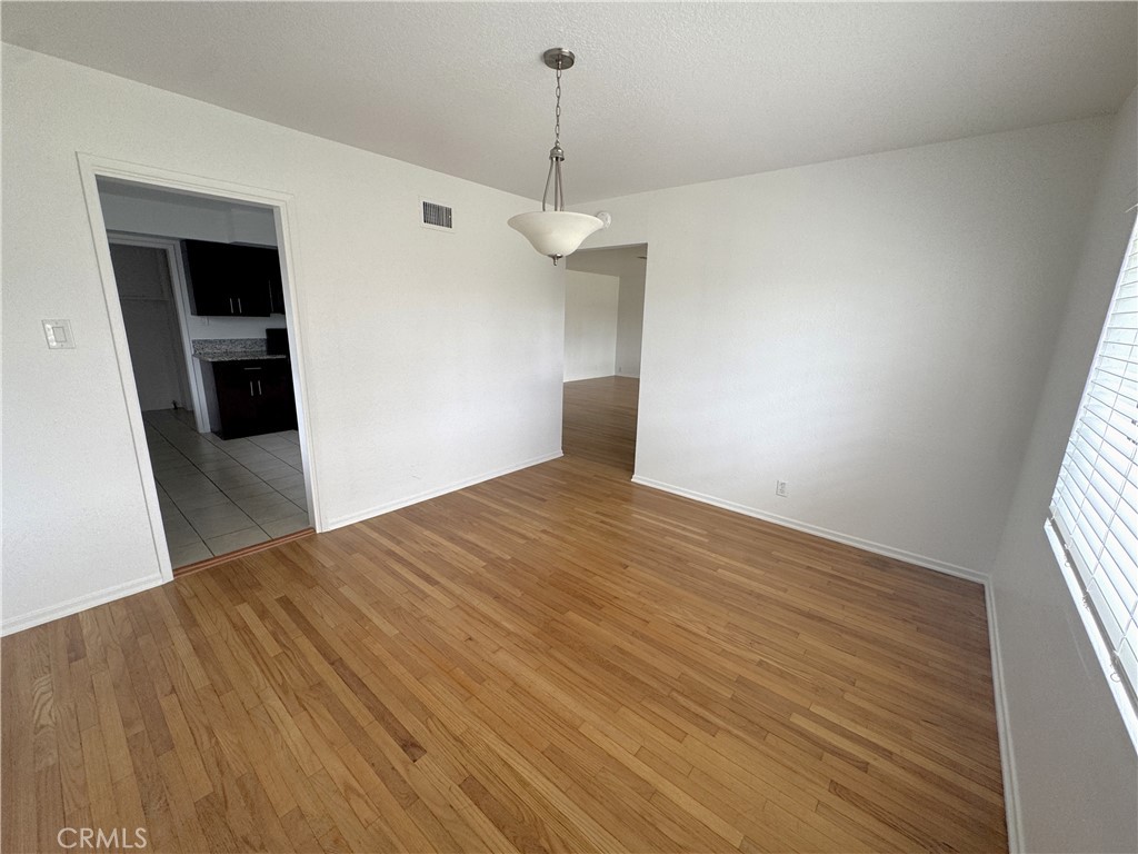 44450 Lowtree Avenue Lancaster, CA 93534 - Photo 7 of 24 wooden floor in an empty room with a window