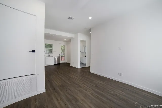 a view of a kitchen with wooden floor and a sink