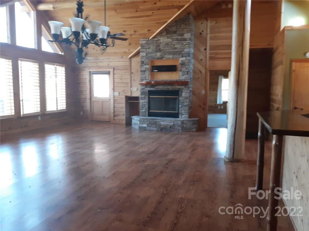 524 Freemantown Road Rutherfordton, NC 28139 - Photo 8 of 43 a view of a living room with furniture a fireplace and wooden floor