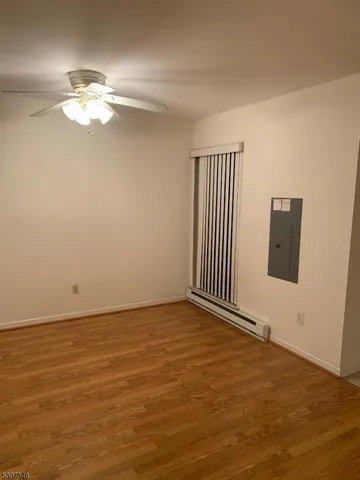 a view of a livingroom with a ceiling fan and window
