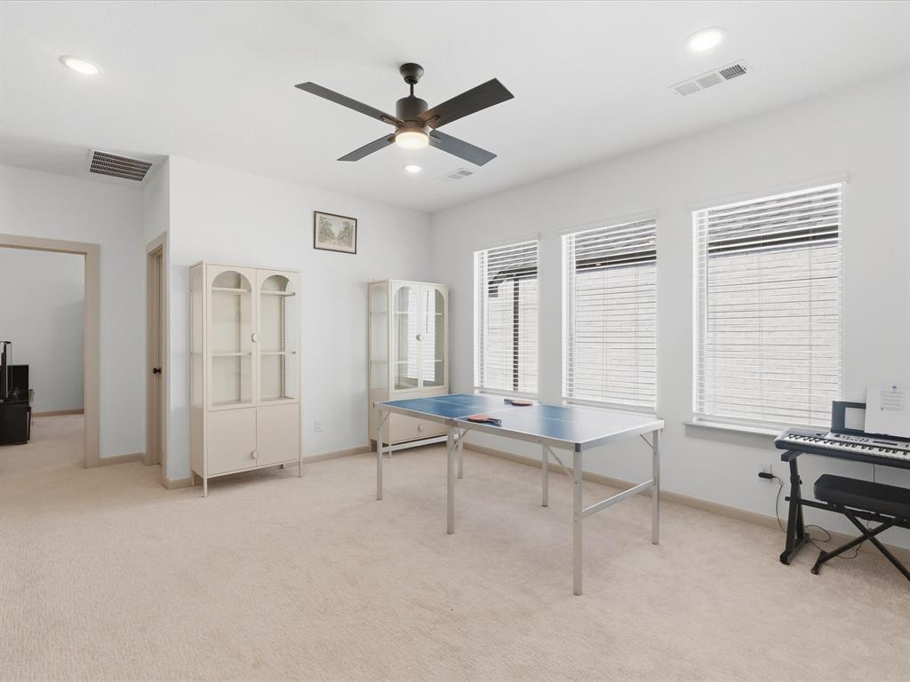 9533 Keep Street Frisco, TX 75035 - Photo 25 of 40 Spacious room featuring light-colored carpeting, multiple windows with blinds, a ceiling fan with integrated lighting, and recessed ceiling lights
