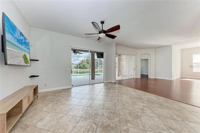 a large kitchen with granite countertop a stove a sink dishwasher and a refrigerator with wooden cabinets