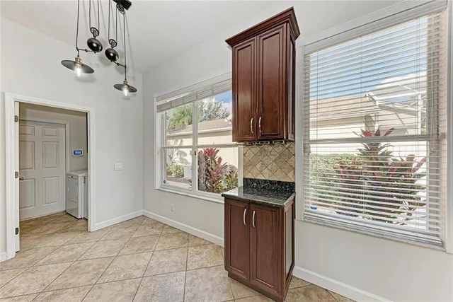 a view of a room with wooden floor and chandelier