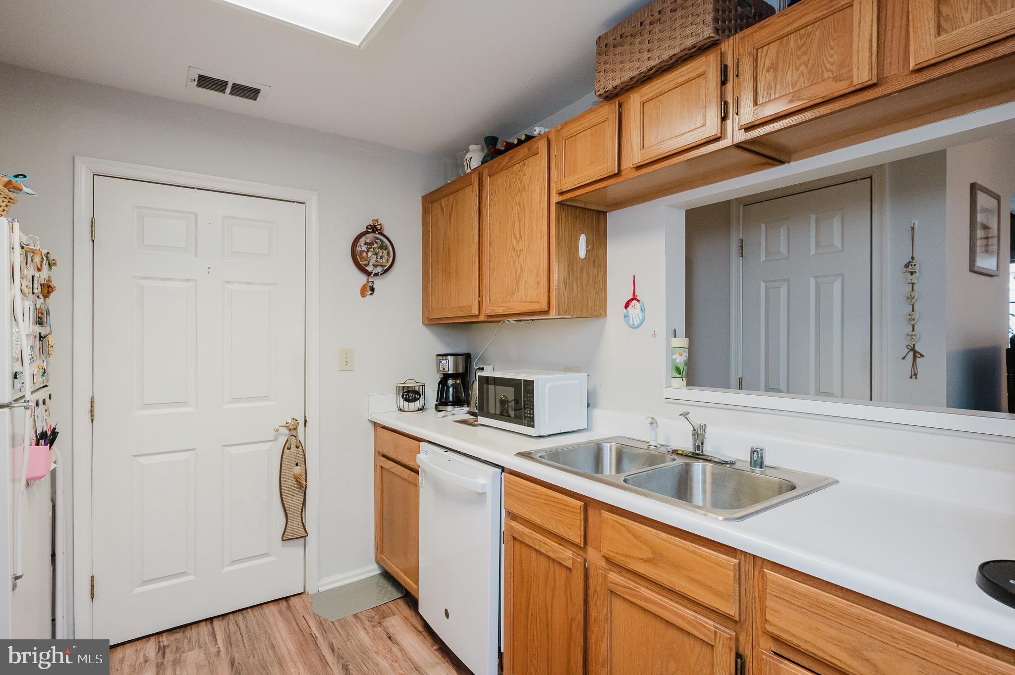 606 Churchill Road, Unit E Bel Air, MD 21014 - Photo 17 of 29 a kitchen with stainless steel appliances granite countertop a sink and cabinets with wooden floor