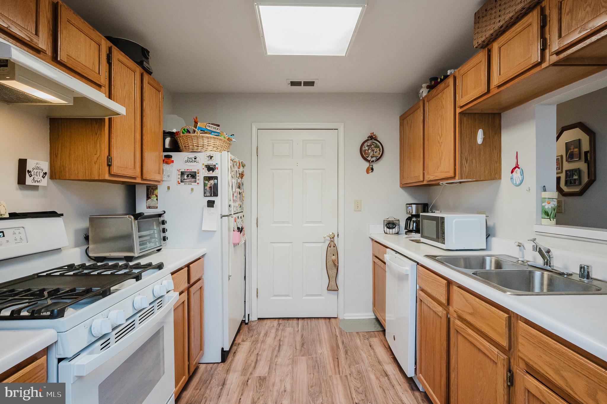 606 Churchill Road, Unit E Bel Air, MD 21014 - Photo 18 of 29 a kitchen with stainless steel appliances a sink a stove a refrigerator and cabinets