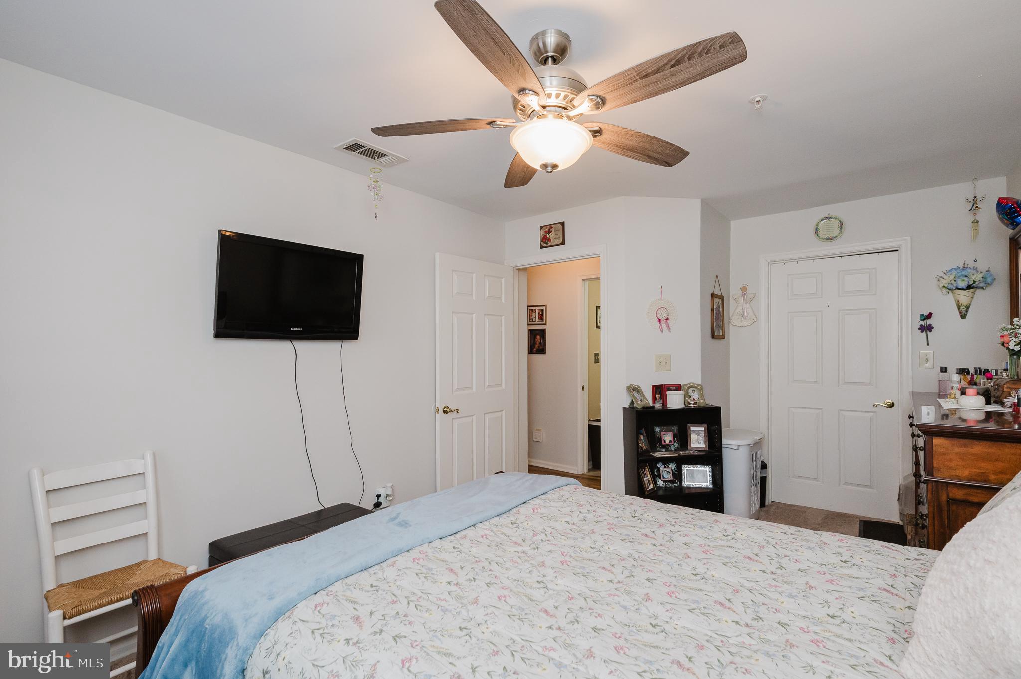 606 Churchill Road, Unit E Bel Air, MD 21014 - Photo 26 of 29 a bedroom with a bed and a flat screen tv