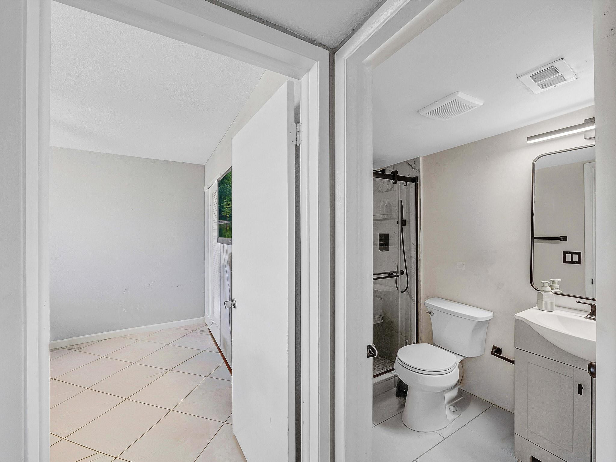 4500 North Federal Highway, Unit 303 Lighthouse Point, FL 33064 - Photo 13 of 40 a bathroom with a toilet and a shower